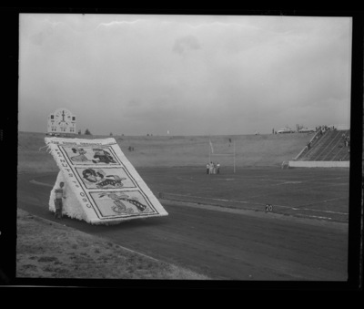 Homecoming float group contest winner, built by Phi Gamma Delta and Kappa Kappa Gamma, shows a Peanuts cartoon on the sidelines of Neale Stadium for the homecoming game.