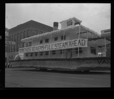 A homecoming float made to look like a steam barge that reads "DAMN THOSE BEAVERS-FULL STEAM AHEAD".