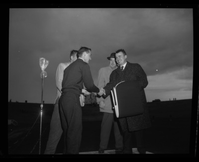 Homecoming chairman presents an honorees with an "I" blanket during halftime at the 1958 homecoming game.