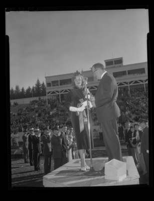 Homecoming queen Trenna Atchley being crowned by Elbert Stellmon, president of the Lewiston Alumni Chapter, during halftime at the 1959 Homecoming Game.