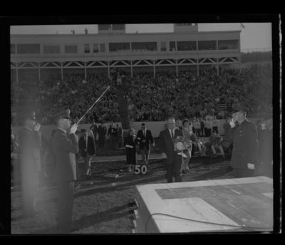 Homecoming queen Trenna Atchley being escorted to the stage at the Homecoming game halftime.