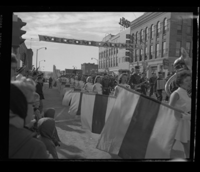 The marching band and color guard marching in the Homecoming parade.