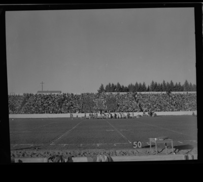 The cheerleaders and members of the yell squad lead the crowd during halftime in making an "I" in the stands.