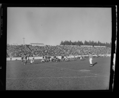 Football players on the field during the Homecoming game.