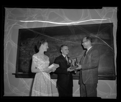 Dr. Kenneth Bush, professor of mathematics, awarding freshman math winners.