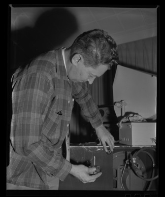 Radio Center advisor Leon Lind fixes a speaker cabinet.