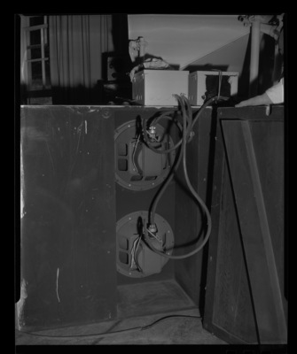 Radio Center advisor Leon Lind shows the inside of a speaker cabinet.