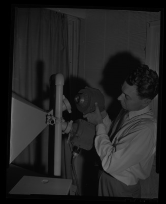 Radio Center advisor Leon Lind adjusts a loud speaker.