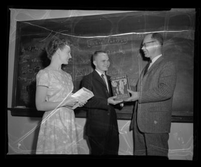 Dr. Kenneth Bush, professor of mathematics, awarding freshman math winners.