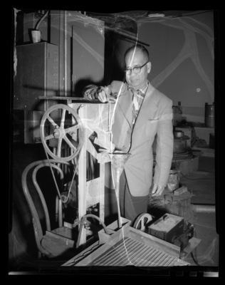 Prof. Ramon Ramos, 1932 UI Civil Engineering alumn and professor of engineering at the University of the Philippines, inspecting equipment in the Old Mines Building.