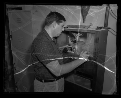 College of Mines student with laboratory equipment.