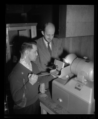 College of Mines student and Professor Donald Clifton working with a Buehler Ltd. Metallurical Apparatus.
