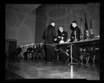 Rear Admiral Frank T. Watkins, Navy, presents an award to a student at the combined ROTC awards ceremony at the University of Idaho.