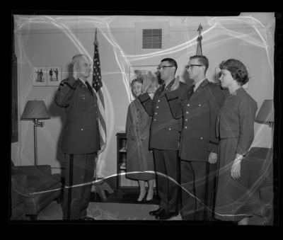Captain Harrison, Army ROTC,  swearing in Robert Prestel (left) and Charles Brockway (right) at the University of Idaho.