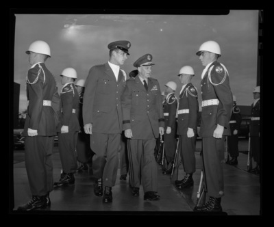 Major General Gilman C. Mudgett inspects the ROTC units at the University of Idaho with escort while walking into Memorial Gym.