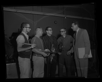Orchestra members talk with Professor Leroy Bauer.