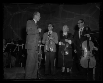 Orchestra members practice together.