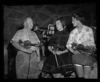 Violin players practice together.