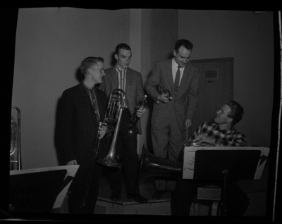 Members of the symphony orchestra's horn section practice together.