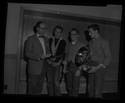 Dean of Music, Hall Macklin, shows a pamphlet about the University of Idaho to visiting high school music students.