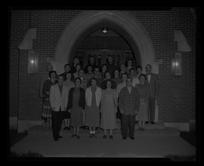 School of Music students and teachers outside of the music building. Dean of Music, Hall Macklin, on far right.