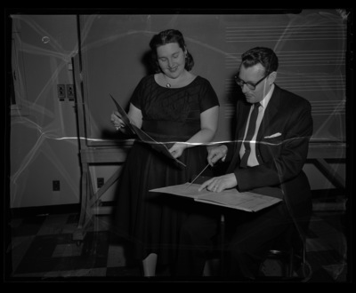 School of Music Professor LeRoy Bauer and sololist Mrs. Barnes looking over a score for a concert.