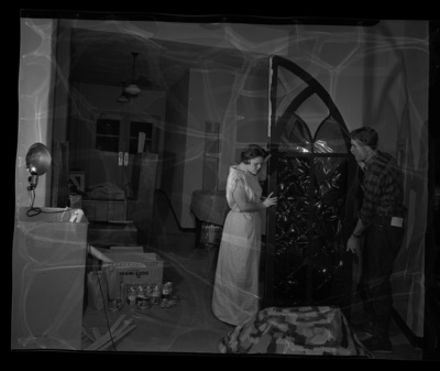 Two students move set pieces backstage for the annual "Evening of Opera" workshop presented by the School of Music.