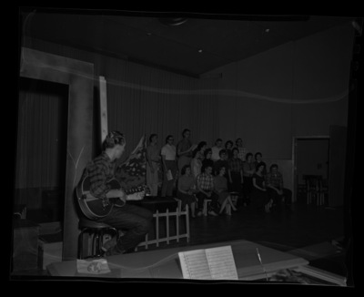 Students rehearse a scene from Down in the Valley for the annual "Evening of Opera" workshop presented by the School of Music. DeLance Franklin, as the narrator, sits with his guitar in the foreground.