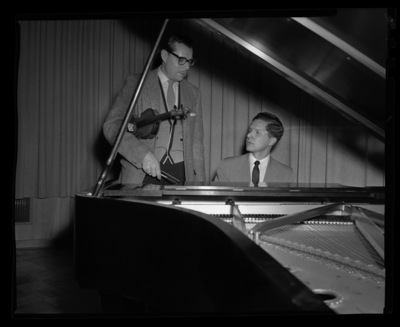 Music Professor LeRoy Bauer speaks with student pianist.