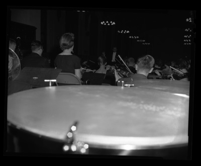 Professor LeRoy Bauer conducts University of Idaho symphony orchestra.