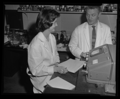 O.B. Weeks and student Kay Boyarth working on Heart Association project in a lab.