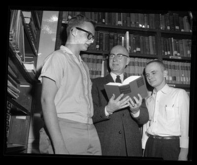 Students Corder Campbell (left) and William Kindley (right) receiving awards for freshman achievements in chemistry and physics from Dr. Malcom Renfrew (center).