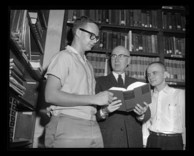 Students Corder Campbell (left) and William Kindley (right) receiving awards for freshman achievements in chemistry and physics from Dr. Malcom Renfrew (center).