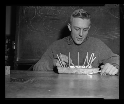 Student in zoology laboratory looking at a disected specimen.