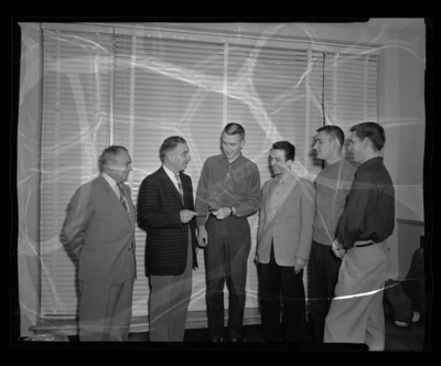 Interfraternity Council (IFC) donating $100 to Iranian student.