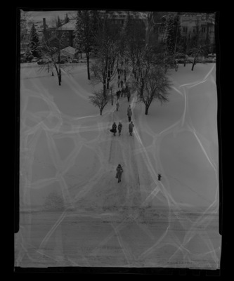Students walking on snow-covered sidewalks on the north side of the Administration Building.