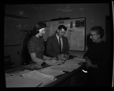 Mrs. Hale in the Placement Office signing up students for job interviews.