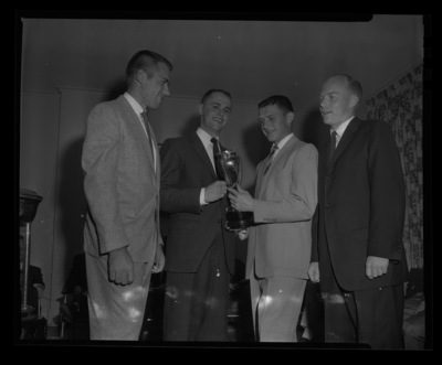 Students with Sigma Chi trophy