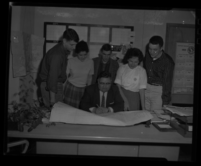 Gale Mix and students review the flor plans for the new SUB addition that would include the Internaitonal Ballroom