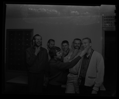 A woman checks the progress of the Dad's Day beard-growing contestants.