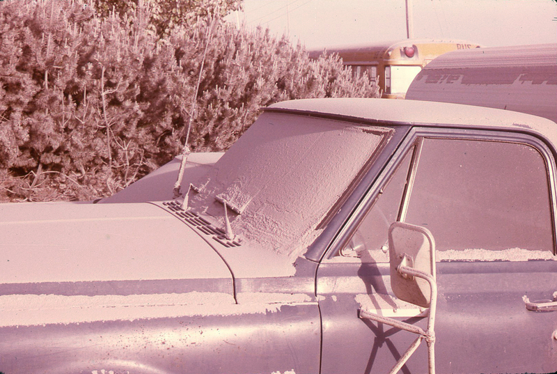 Blue truck covered in ash