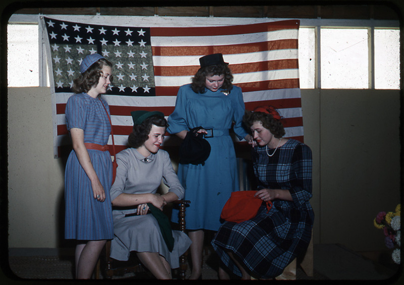 Four women in front of the American flag
