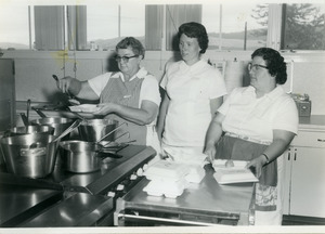 Three women packing meals [1]