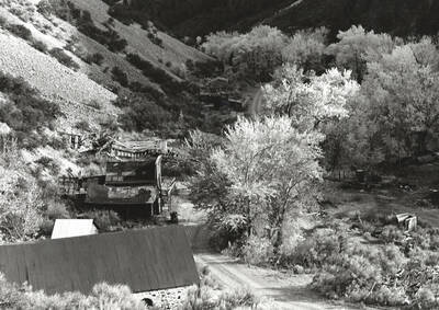 Light and shadow play off this remote ghost town. This image of falling down buildings and a road was entered into Boise Camera Club competition and received a score of 20.