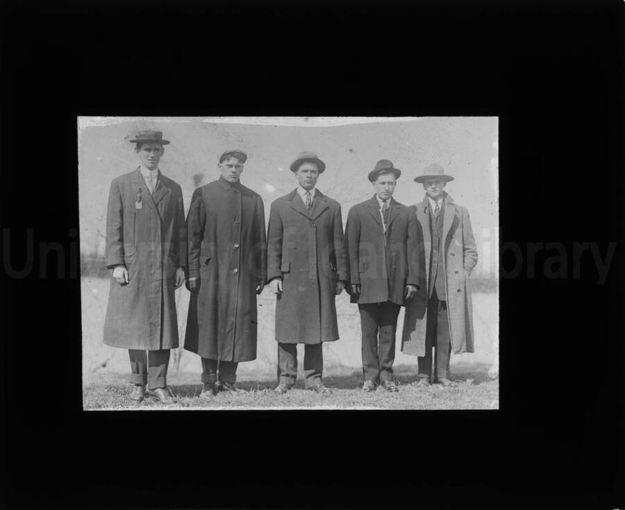A portrait of five unidentified men, standing in order from tallest to shortest