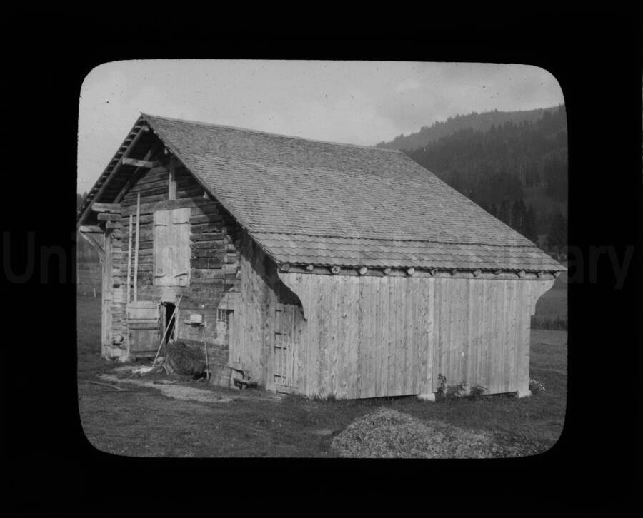A farm building, built using logs and shake shingles.