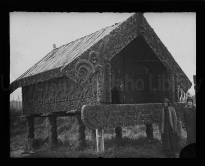 Maud Iddings with unidentified woman outside a small ceremonial building, the external walls of which are exquisitely decorated.