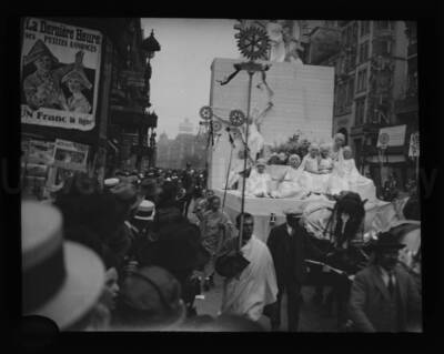 Street parade with a group of persons carrying Rotary International logo in Belgium.