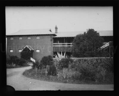 A building with a landscaped garden in the foreground.