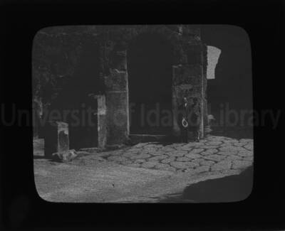 Maude and E. J. Iddings posing in front of an old church building.